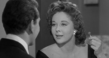 Movie still from “I'll Cry Tomorrow” (1955), directed by Daniel Mann – An old photo of a woman looking at a young man; Close Up shot, Over the shoulder angle