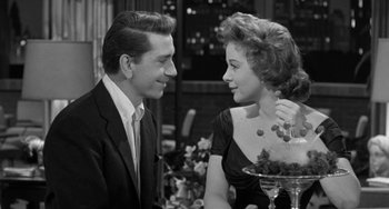 Movie still from “I'll Cry Tomorrow” (1955), directed by Daniel Mann – A man and a woman sitting in front of a table; Medium shot, Over the shoulder angle