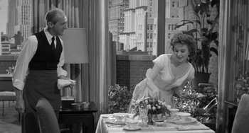 Movie still from “I'll Cry Tomorrow” (1955), directed by Daniel Mann – An old photo of a man and a woman cutting a cake; Medium shot, Over the shoulder angle
