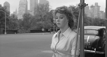 Movie still from “I'll Cry Tomorrow” (1955), directed by Daniel Mann – A black and white photo of a woman standing in the street; Medium shot, Low angle