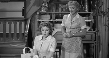 Movie still from “I'll Cry Tomorrow” (1955), directed by Daniel Mann – Two women are standing in a kitchen and one of the women is holding a plate; Medium shot, Low angle