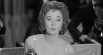 Movie still from “I'll Cry Tomorrow” (1955), directed by Daniel Mann – An old photo of a woman in a black dress; Close Up shot, High angle