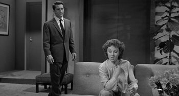 Movie still from “I'll Cry Tomorrow” (1955), directed by Daniel Mann – A man and a woman sitting on a couch; Medium shot, Low angle