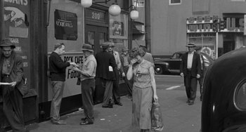 Movie still from “I'll Cry Tomorrow” (1955), directed by Daniel Mann – A group of people standing on the side of the street; Wide shot, High angle