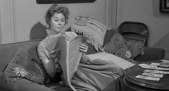 Movie still from “I'll Cry Tomorrow” (1955), directed by Daniel Mann – A black and white photo of a woman sitting on a bed; Medium shot, High angle