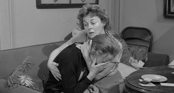 Movie still from “I'll Cry Tomorrow” (1955), directed by Daniel Mann – An old photo of a woman hugging a man on a couch; Medium shot, High angle