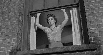 Movie still from “I'll Cry Tomorrow” (1955), directed by Daniel Mann – An old black and white photo of a woman looking out of a window; Medium shot, Low angle