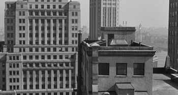 Movie still from “I'll Cry Tomorrow” (1955), directed by Daniel Mann – A black and white photo of some buildings in a city; Extreme Wide shot, Low angle