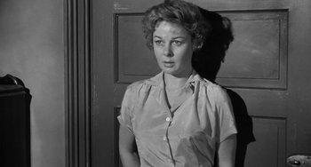Movie still from “I'll Cry Tomorrow” (1955), directed by Daniel Mann – A black and white photo of a woman standing in front of a door; Close Up shot, Low angle