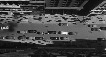 Movie still from “I'll Cry Tomorrow” (1955), directed by Daniel Mann – An overhead view of a busy city street at night; Extreme Wide shot, Overhead angle