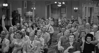Movie still from “I'll Cry Tomorrow” (1955), directed by Daniel Mann – A group of men and women sitting in front of a microphone; Wide shot, High angle