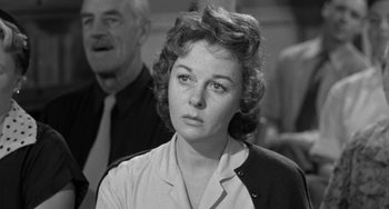Movie still from “I'll Cry Tomorrow” (1955), directed by Daniel Mann – An old photo of an older woman looking at the camera; Close Up shot, Over the shoulder angle