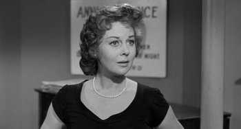 Movie still from “I'll Cry Tomorrow” (1955), directed by Daniel Mann – An old photo of a woman in a black dress; Close Up shot, Over the shoulder angle