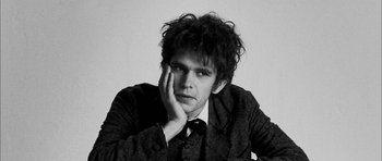 Movie still from “I'm Not There” (2007), directed by Todd Haynes – Black and white photograph of a man in a suit; Close Up shot, Low angle