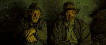 Movie still from “I'm Not There” (2007), directed by Todd Haynes – A couple of men sitting next to each other in a room; Medium shot, Overhead angle