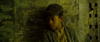 Movie still from “I'm Not There” (2007), directed by Todd Haynes – A man wearing a hat and a yellow shirt; Close Up shot, Overhead angle