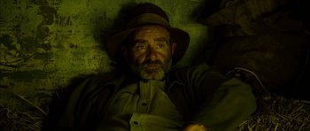 Movie still from “I'm Not There” (2007), directed by Todd Haynes – An old man with a beard and a hat is laying down; Close Up shot, High angle