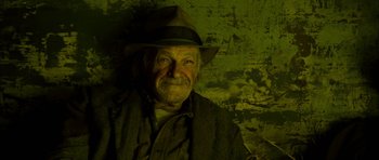 Movie still from “I'm Not There” (2007), directed by Todd Haynes – An old man wearing a hat and a jacket; Close Up shot, Low angle