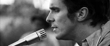 Movie still from “I'm Not There” (2007), directed by Todd Haynes – A person with a microphone; Extreme Close Up shot, Low angle