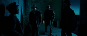 Movie still from “I'm Not There” (2007), directed by Todd Haynes – A couple of men standing next to each other in the dark; Medium shot, Low angle
