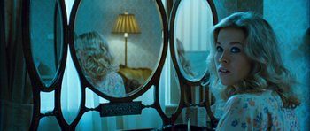 Movie still from “I'm Not There” (2007), directed by Todd Haynes – A woman sitting in front of a mirror looking at herself in the mirror; Medium shot, Over the shoulder angle