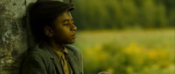 Movie still from “I'm Not There” (2007), directed by Todd Haynes – A young man wearing a hat and a jacket; Close Up shot, Low angle