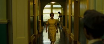Movie still from “I'm Not There” (2007), directed by Todd Haynes – A woman walking down a hallway in a hospital; Wide shot, Low angle