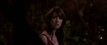 Movie still from “I'm Not There” (2007), directed by Todd Haynes – A beautiful young lady in front of a forest; Close Up shot, Over the shoulder angle