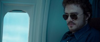 Movie still from “I'm Not There” (2007), directed by Todd Haynes – A person wearing sunglasses; Close Up shot, Over the shoulder angle