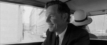 Movie still from “I'm Not There” (2007), directed by Todd Haynes – Black and white photograph of a man in a car; Close Up shot, Over the shoulder angle