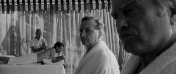 Movie still from “I'm Not There” (2007), directed by Todd Haynes – An older man wearing a white robe in front of a curtain; Close Up shot, Over the shoulder angle