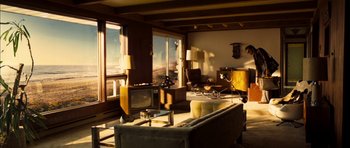 Movie still from “I'm Not There” (2007), directed by Todd Haynes – A living room filled with furniture next to a large window; Extreme Wide shot, High angle