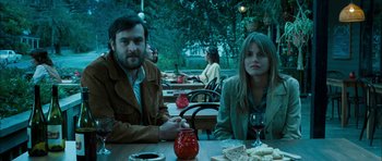 Movie still from “I'm Not There” (2007), directed by Todd Haynes – A man and a woman sitting at a table; Medium shot, High angle