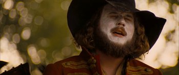 Movie still from “I'm Not There” (2007), directed by Todd Haynes – A man with a long beard and a cowboy hat; Close Up shot, Low angle