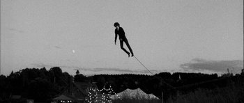 Movie still from “I'm Not There” (2007), directed by Todd Haynes – A man flying through the air while riding a kite; Wide shot, Low angle