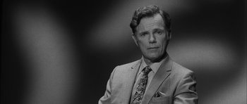 Movie still from “I'm Not There” (2007), directed by Todd Haynes – Black and white photograph of a man wearing a suit and tie; Close Up shot, Low angle