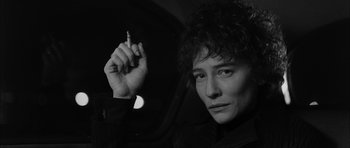 Movie still from “I'm Not There” (2007), directed by Todd Haynes – A woman holding a cigarette in her hand; Close Up shot, Low angle