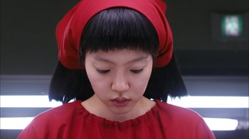 Movie still from “I'm a Cyborg, But That's OK” (2006), directed by Park Chan-wook – A young girl in a red dress and a red hat; Close Up shot, Overhead angle