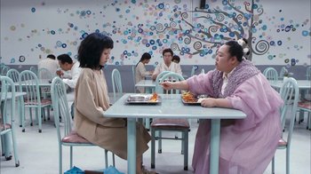 Movie still from “I'm a Cyborg, But That's OK” (2006), directed by Park Chan-wook – Two women sitting at a table with plates of food in front of them; Wide shot, High angle