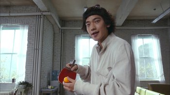Movie still from “I'm a Cyborg, But That's OK” (2006), directed by Park Chan-wook – A man holding a ping pong paddle and a ball; Medium shot, Low angle