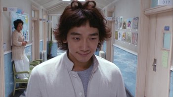 Movie still from “I'm a Cyborg, But That's OK” (2006), directed by Park Chan-wook – A young man is standing in the hallway of a school; Close Up shot, Low angle