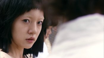Movie still from “I'm a Cyborg, But That's OK” (2006), directed by Park Chan-wook – A person with short black hair; Close Up shot, High angle