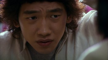 Movie still from “I'm a Cyborg, But That's OK” (2006), directed by Park Chan-wook – A young asian man's face; Close Up shot, Low angle