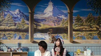 Movie still from “I'm a Cyborg, But That's OK” (2006), directed by Park Chan-wook – Two women sitting in front of a painting of a mountain; Wide shot, Over the shoulder angle
