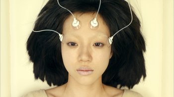Movie still from “I'm a Cyborg, But That's OK” (2006), directed by Park Chan-wook – A young woman with multiple wires attached to her head; Close Up shot, Overhead angle