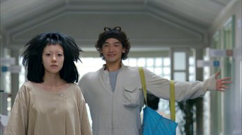 Movie still from “I'm a Cyborg, But That's OK” (2006), directed by Park Chan-wook – A man and a woman are posing for a picture; Medium shot, Low angle