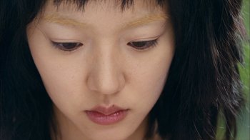 Movie still from “I'm a Cyborg, But That's OK” (2006), directed by Park Chan-wook – A young asian woman's face; Extreme Close Up shot, Overhead angle