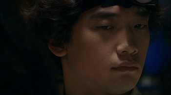 Movie still from “I'm a Cyborg, But That's OK” (2006), directed by Park Chan-wook – A young man's face; Extreme Close Up shot, High angle