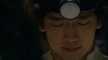 Movie still from “I'm a Cyborg, But That's OK” (2006), directed by Park Chan-wook – A young boy with a magnifying glass on his head; Extreme Close Up shot, Low angle