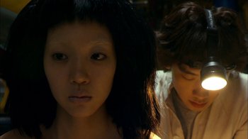 Movie still from “I'm a Cyborg, But That's OK” (2006), directed by Park Chan-wook – Two young people standing next to each other in a room; Close Up shot, High angle